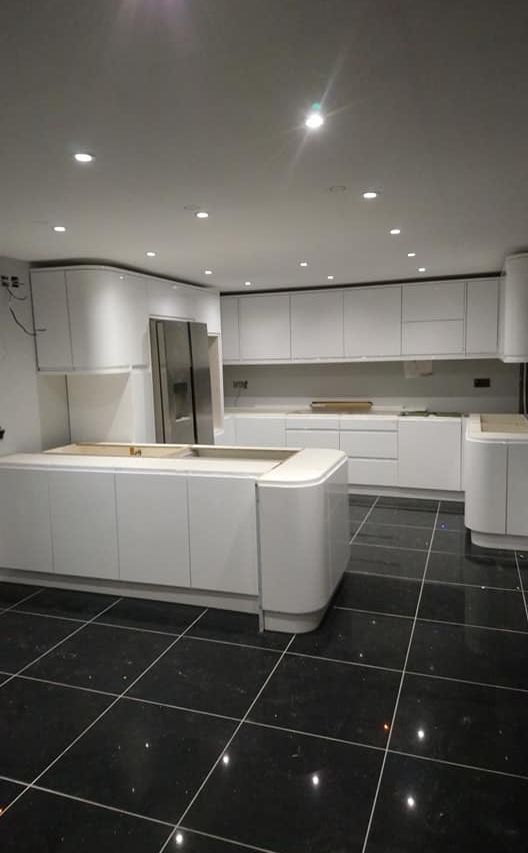 White kitchen with black tile flooring