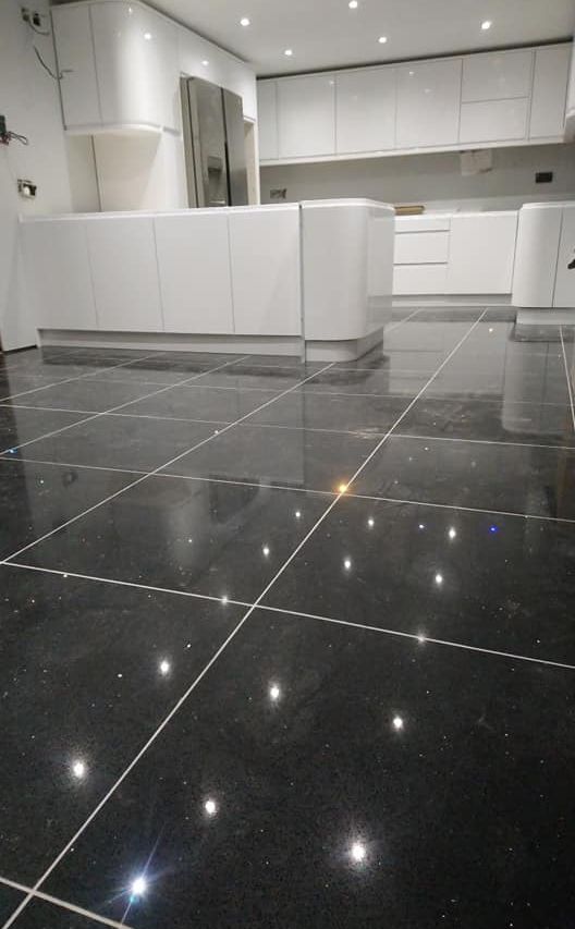 White kitchen with black tile flooring 2